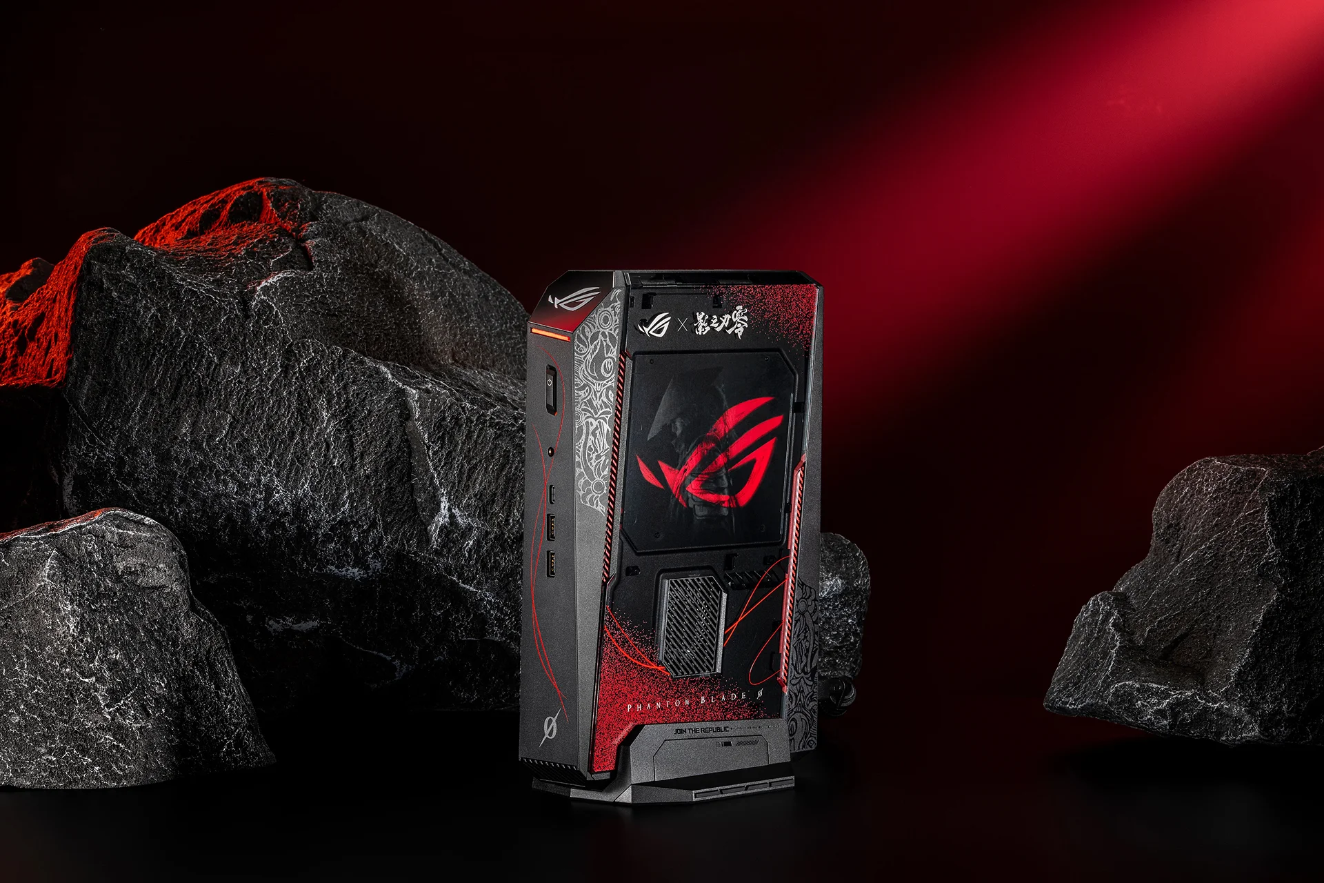 ROG x Phantom Blade Zero gaming NUC mini PC standing upright in a dark rocky environment with red ambient glow.