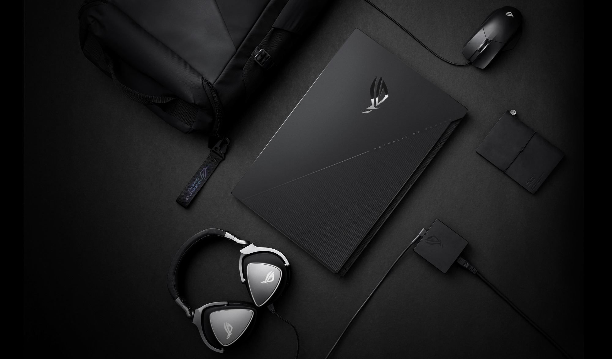 Top down view of the S17, with power adapter, mouse, headset and backpack.
