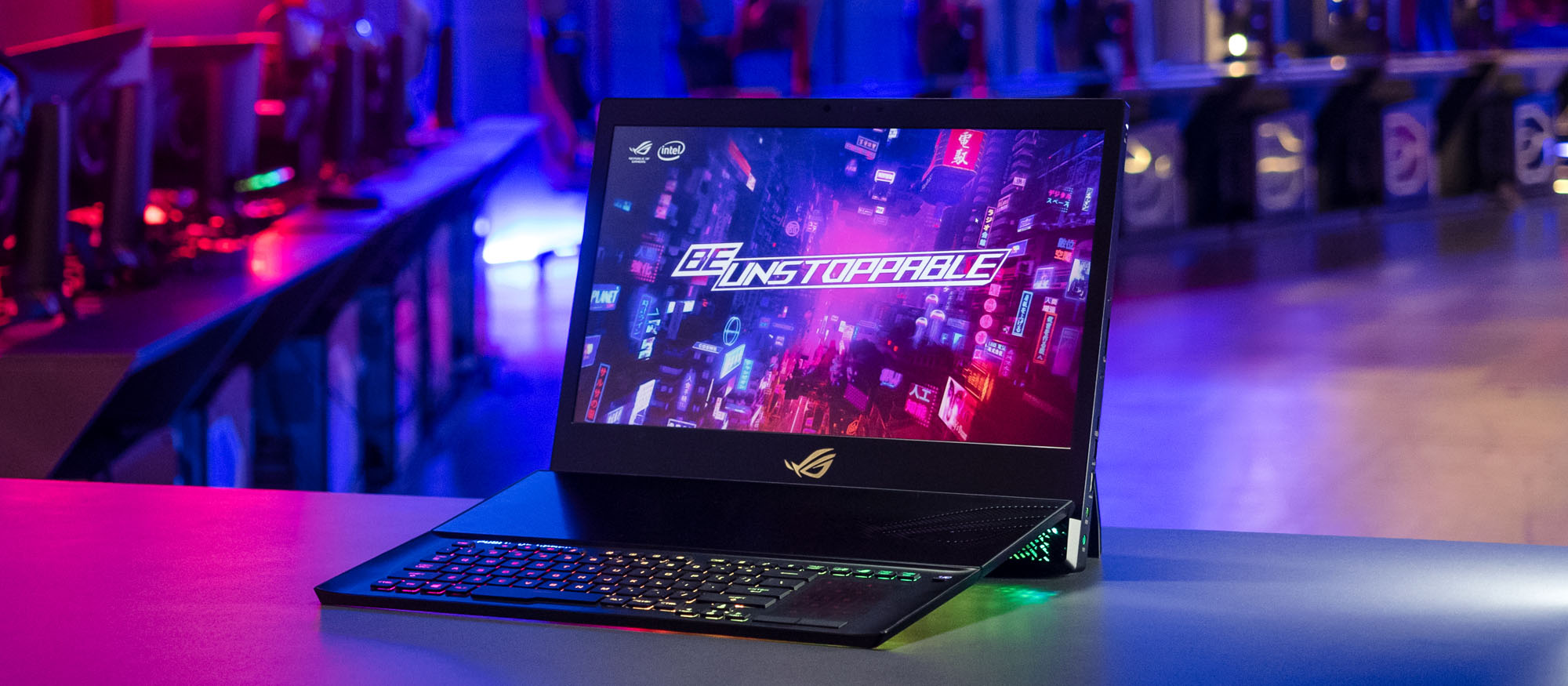 Image of the ROG Mothership on a desk, with more computers in the background.