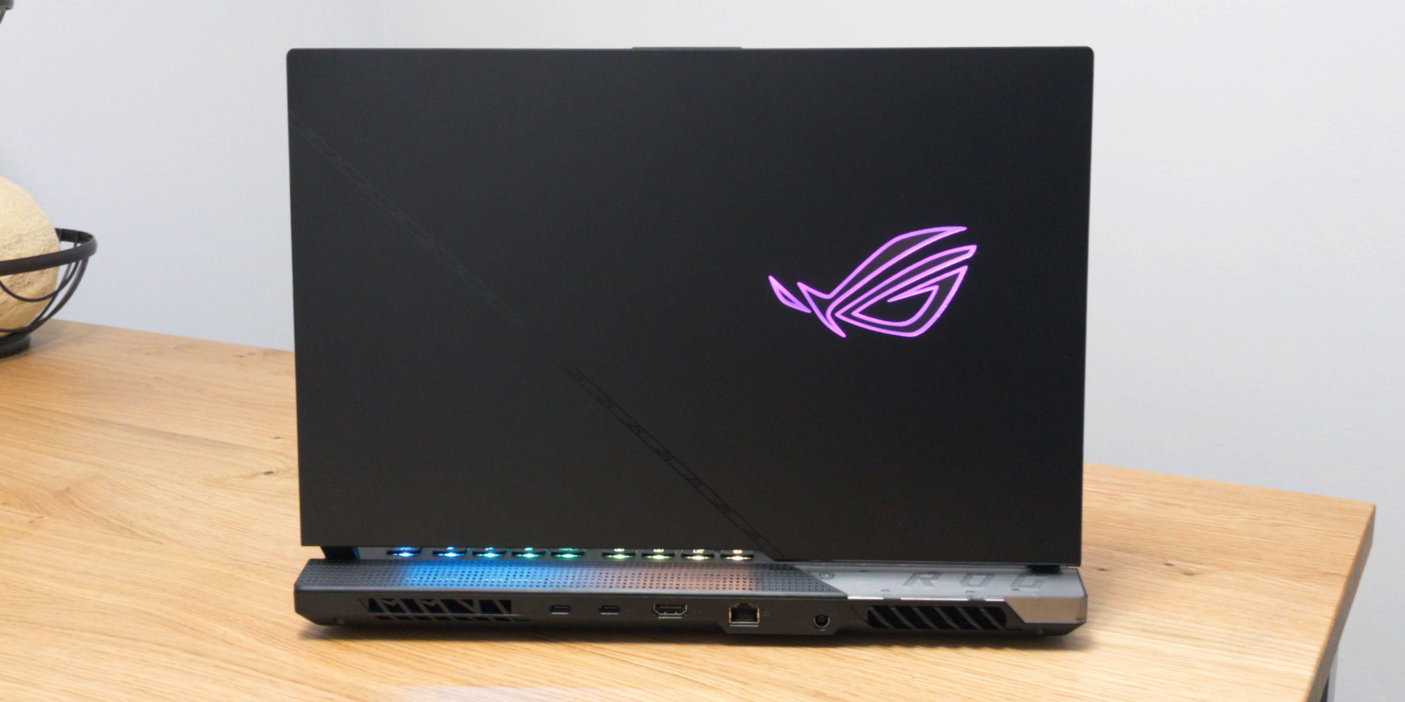 The lid of the SCAR 15 from behind, with the ROG logo illuminated in RGB.