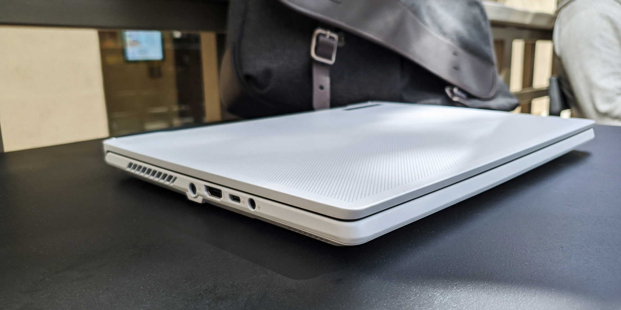 A photo of the Zephyrus G14 laptop with its lid closed, sitting on a table.