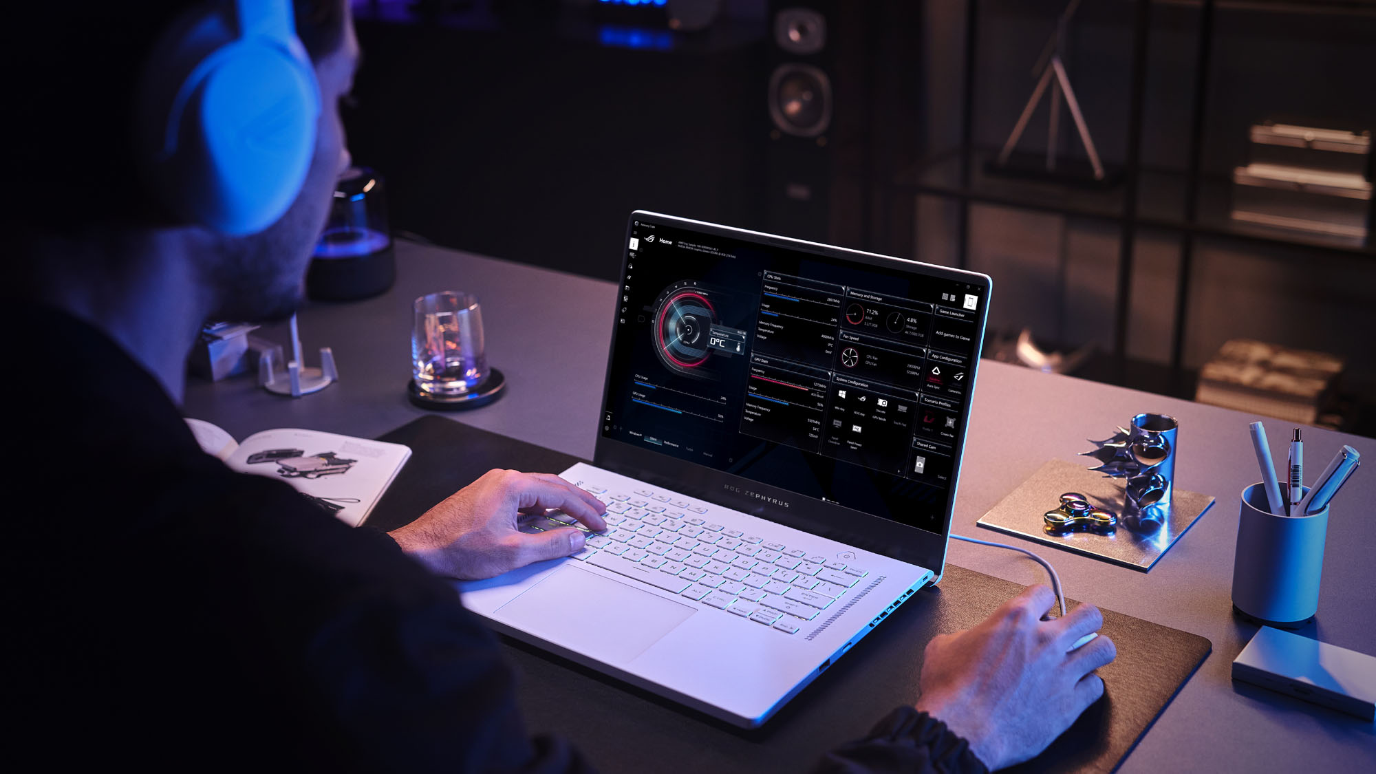 A photo of a Zephyrus G15 laptop on a table, with a gamer using a mouse to navigate Armoury Crate software.