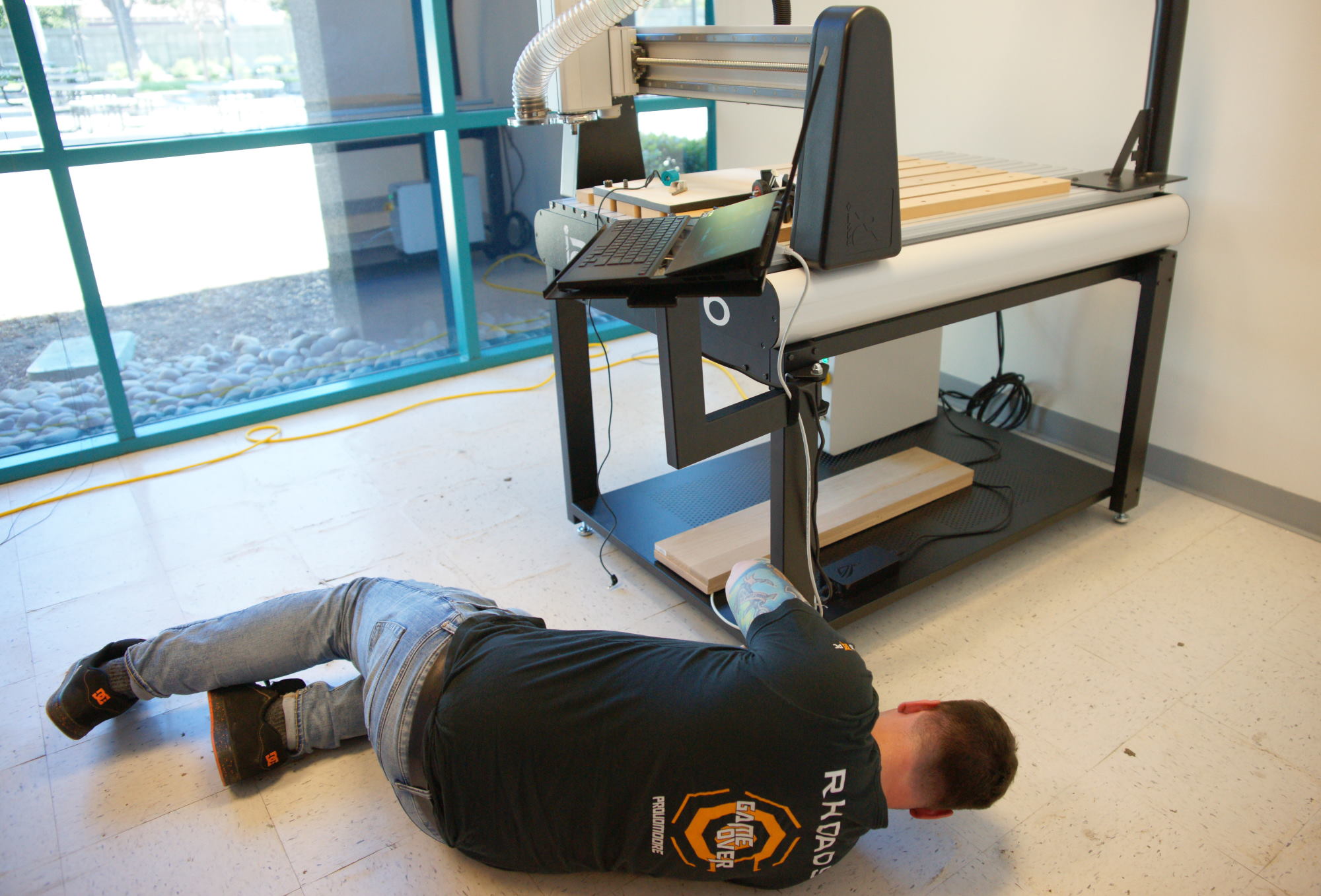 Derek connecting cables to get the i2R machine up and running