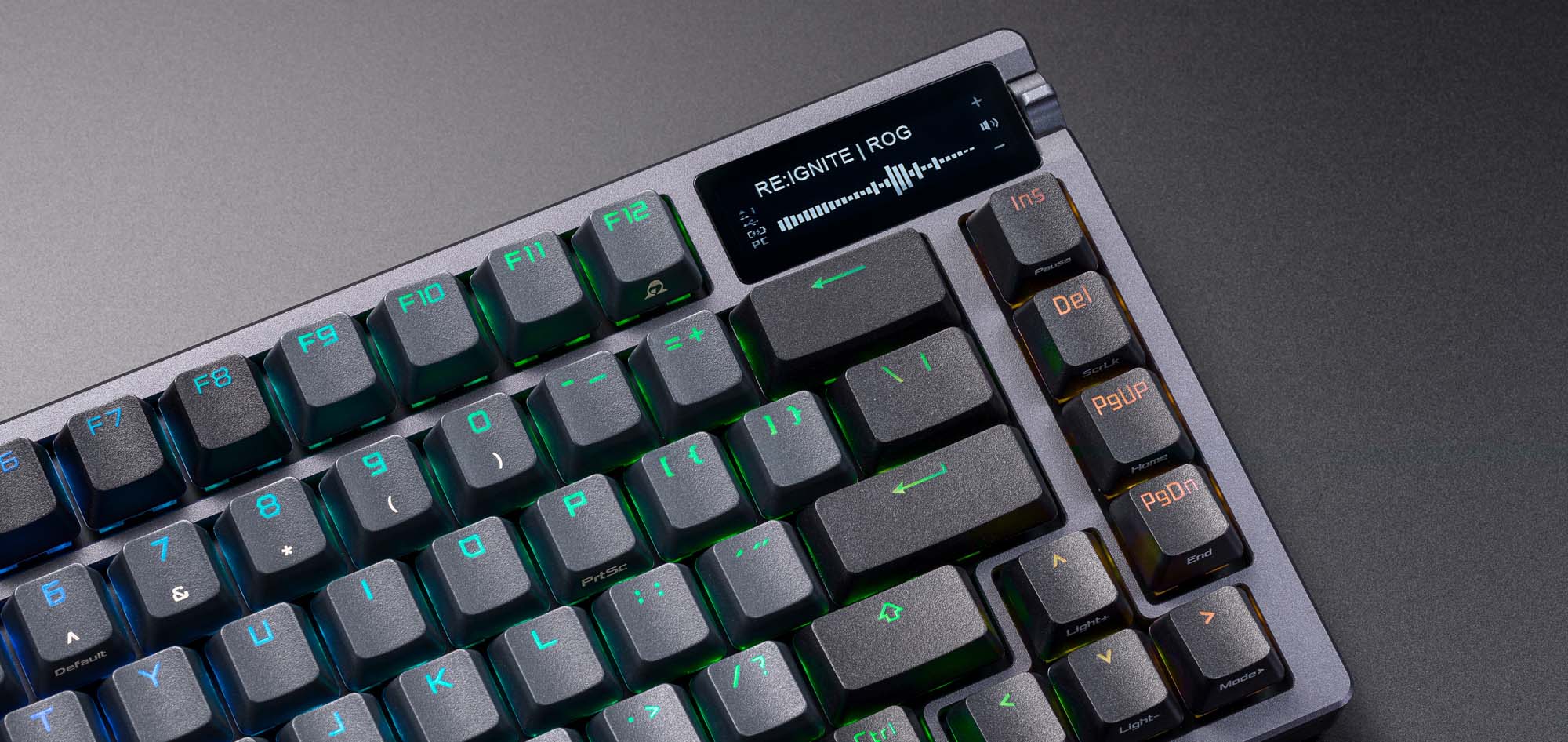 The ROG Azoth keyboard, displaying the currently playing song on its OLED display.
