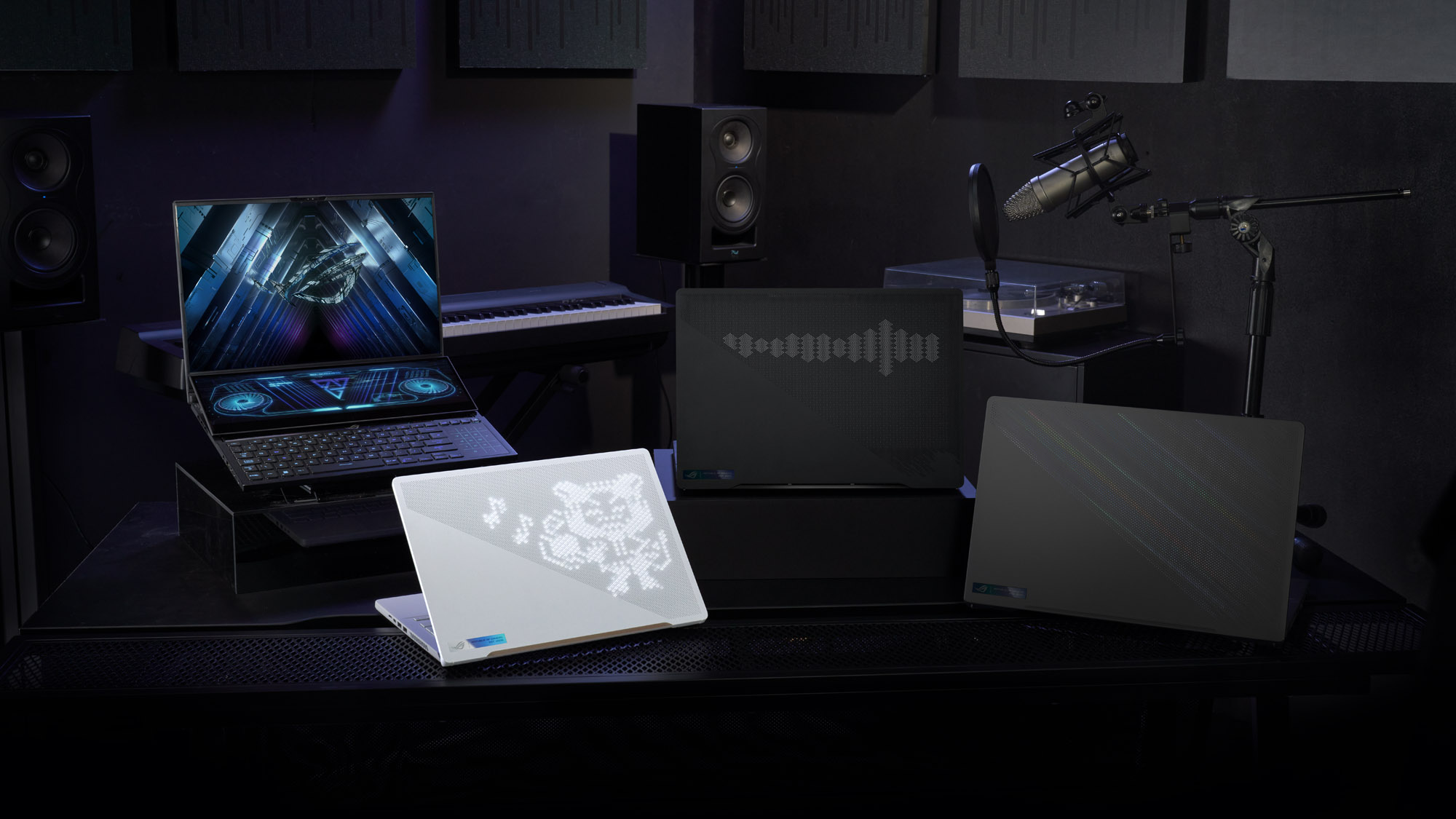 The Zephyrus G14, G16, M16, and Duo 16 sitting on a table at various heights.