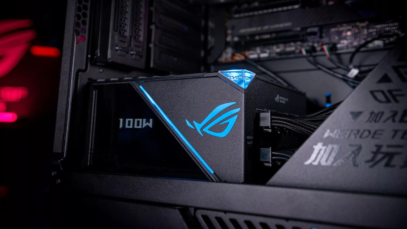 The ROG Thor power supply inside a desktop PC, showing 100W on the OLED display.