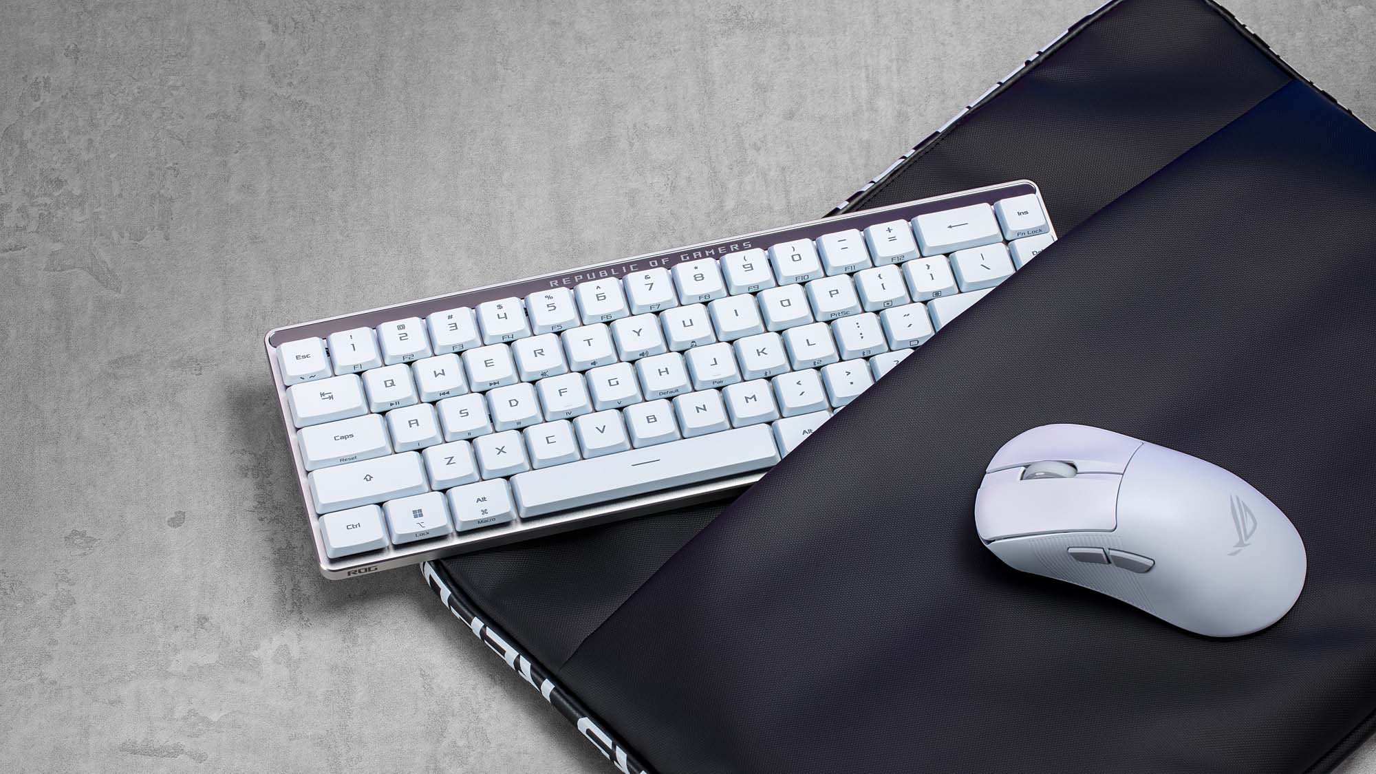 The ROG Falchion RX Low Profile keyboard and ROG Keris II Ace mouse half inserted into a carrying case.