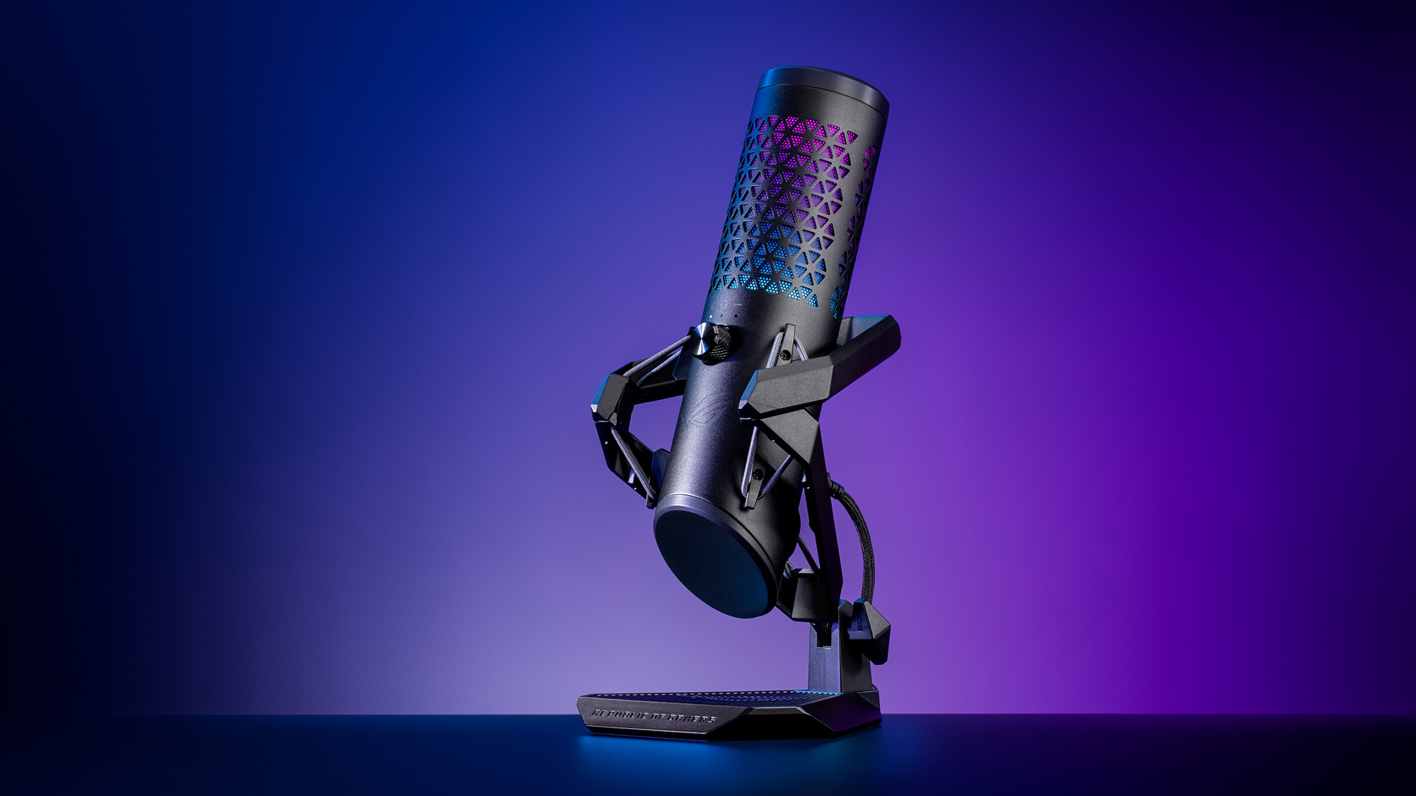 The black ROG Carnyx microphone sitting on a desk with a purple background.