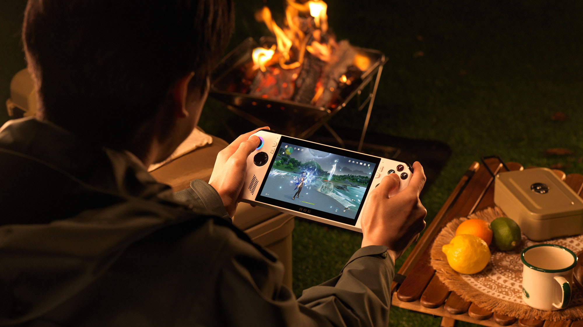 A man playing the ROG Ally in front of a campfire.