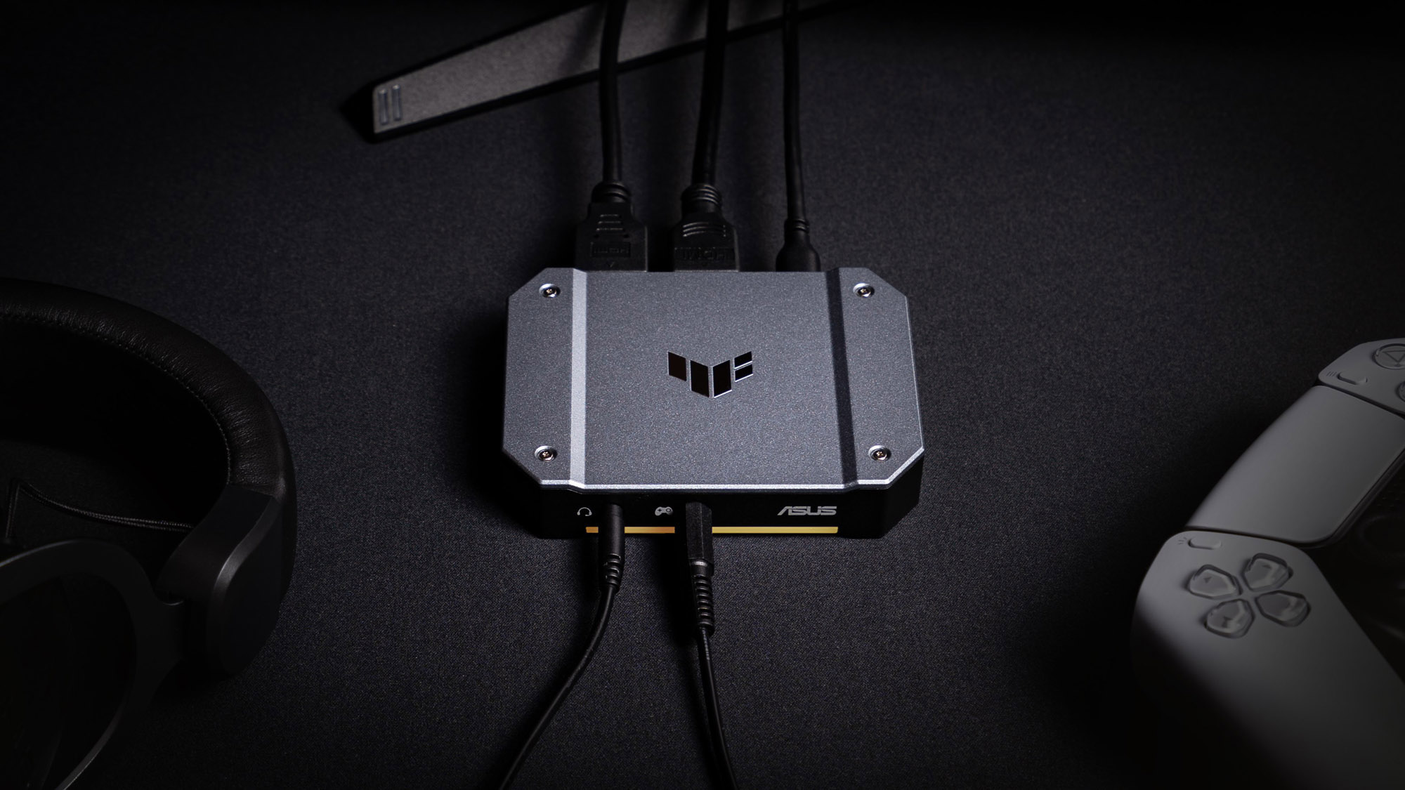 The TUF Gaming CU4K30 Capture Box on a desk.