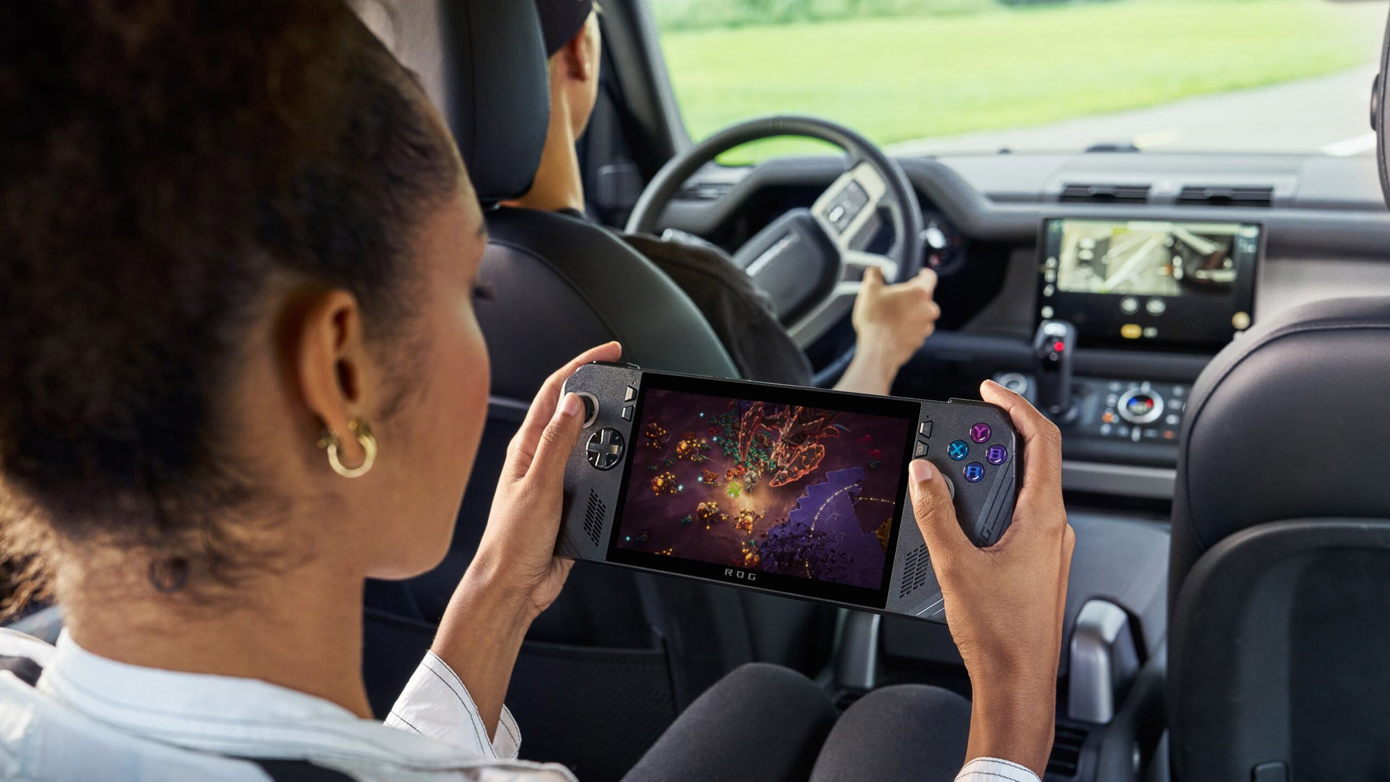 A girl playing the ROG Ally in the back seat of a car.