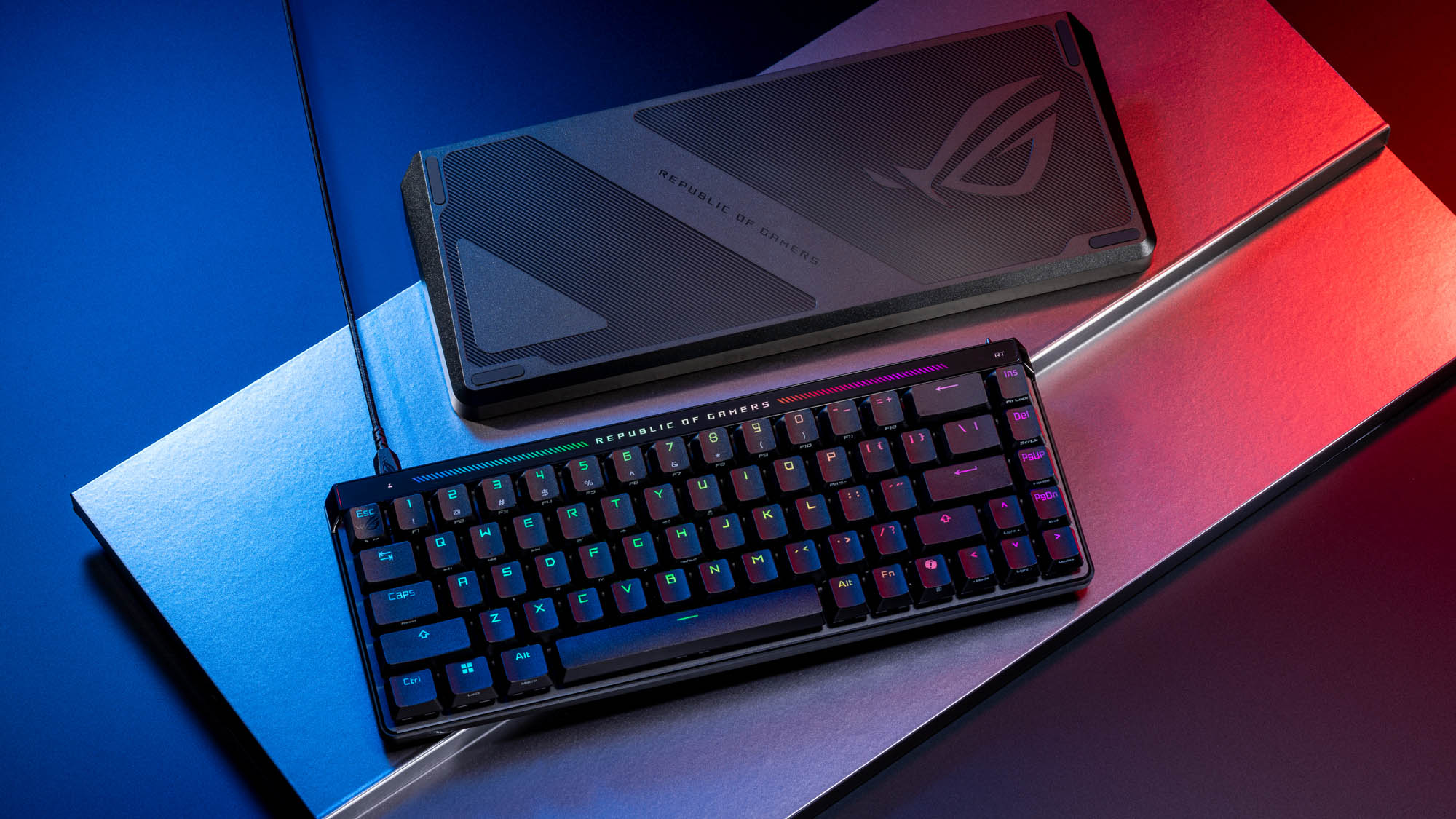 The ROG Falchion Ace HFX lying on a silver platform next to its dust cover.