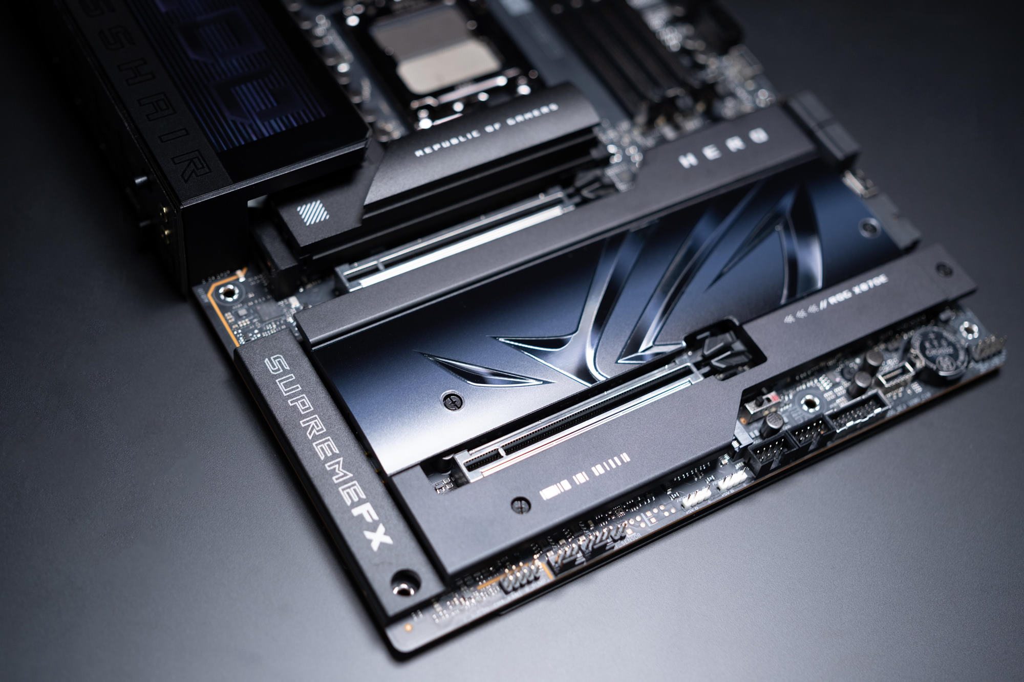 The lower half of the ROG Crosshair X870E Hero motherboard, featuring the M.2 and chipset heatsinks