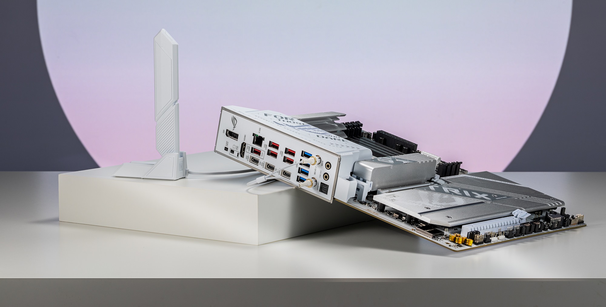 The motherboard leaning on a platform next to the included ASUS WiFi Q-Antenna