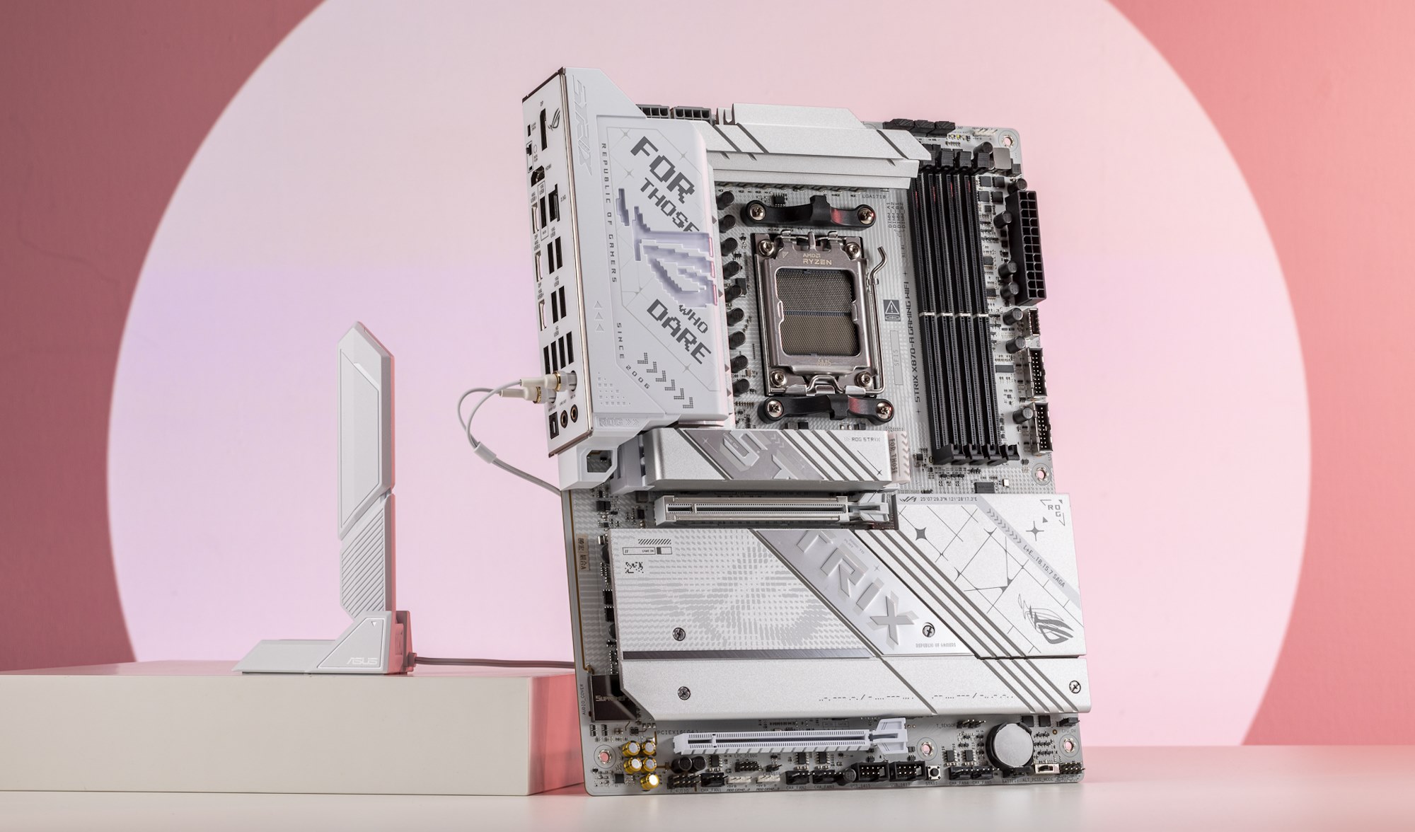 The ROG Strix X870-A Gaming WiFi motherboard standing on a table next to its WiFi antenna