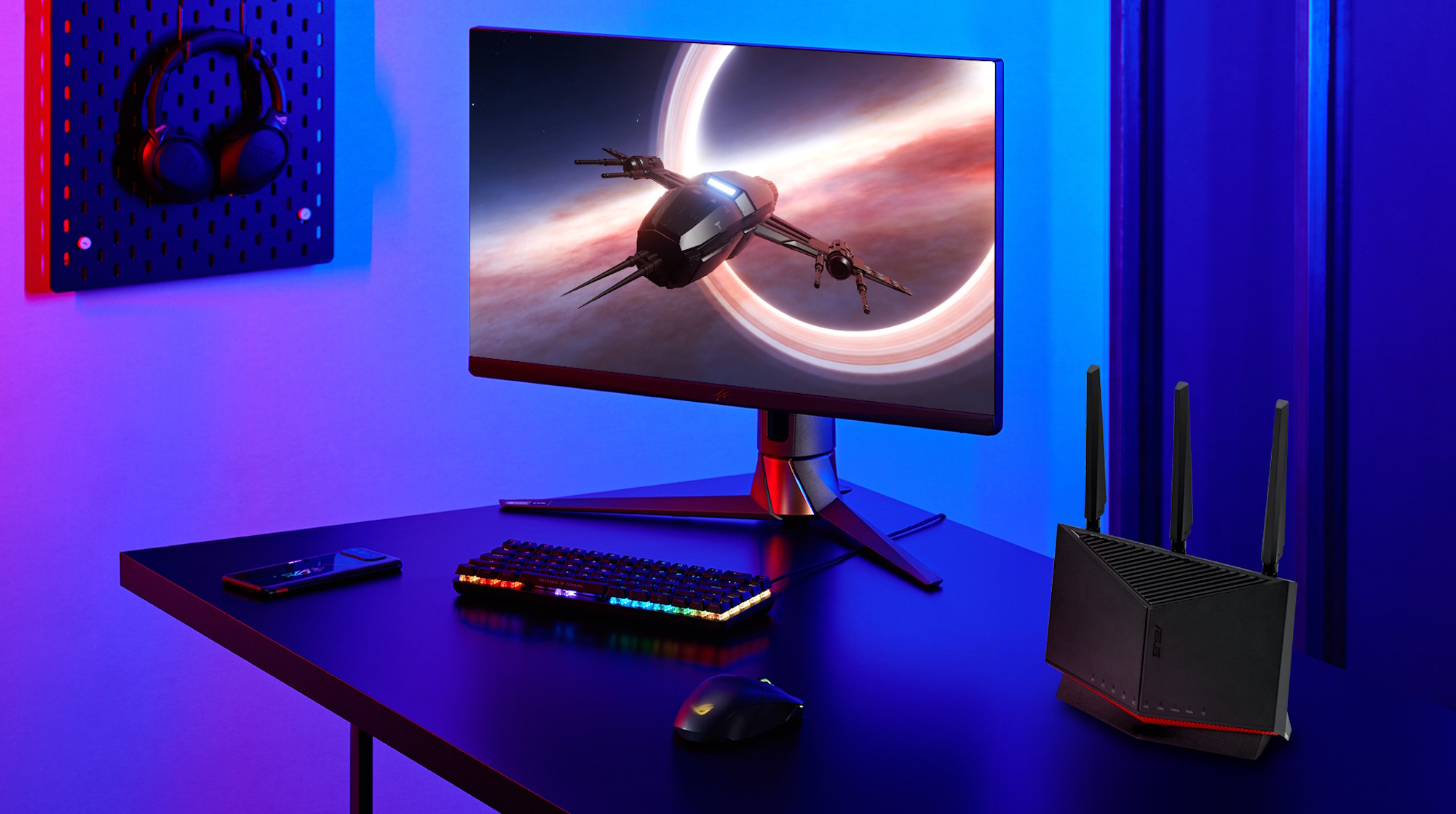 The ASUS RT-BE86U router on a table with other ASUS gaming gear