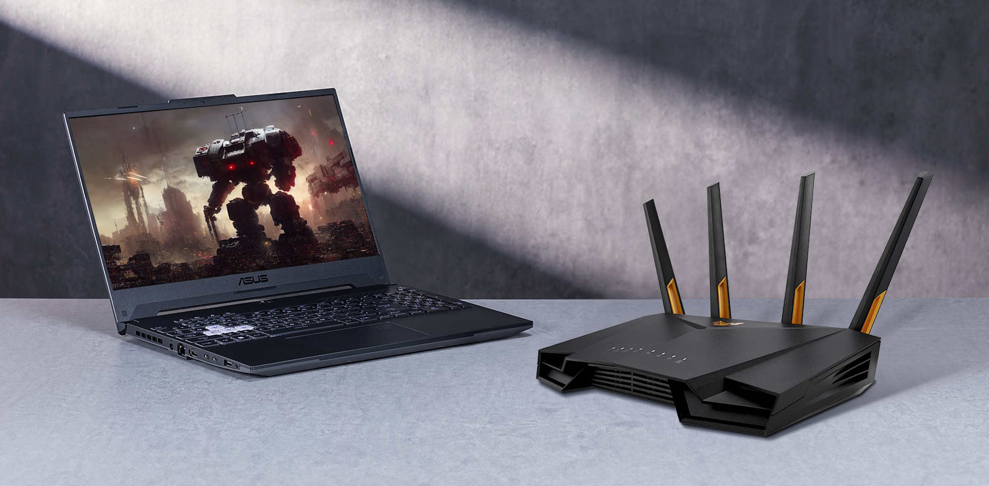 A TUF Gaming wireless router and laptop