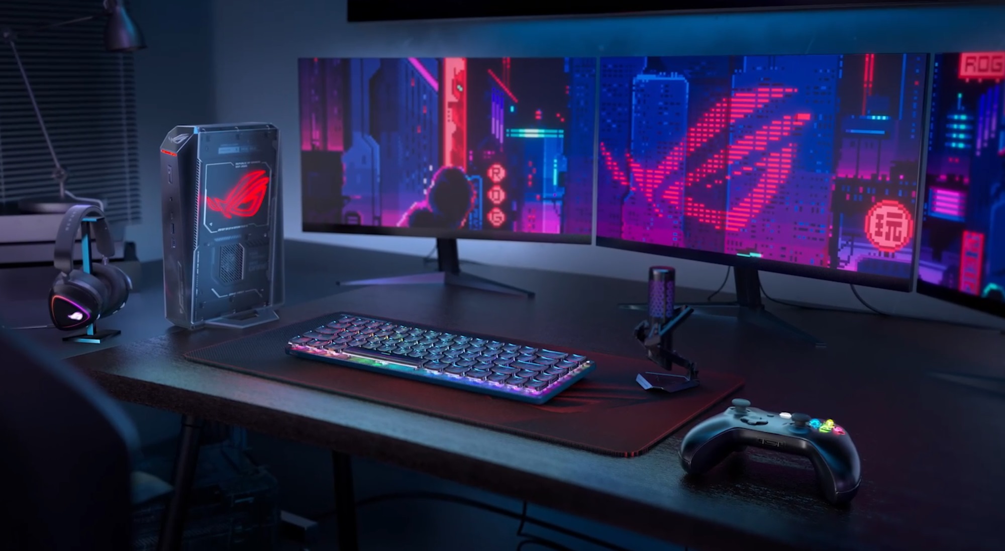 A gaming setup with the ROG NUC on the side of the desk.