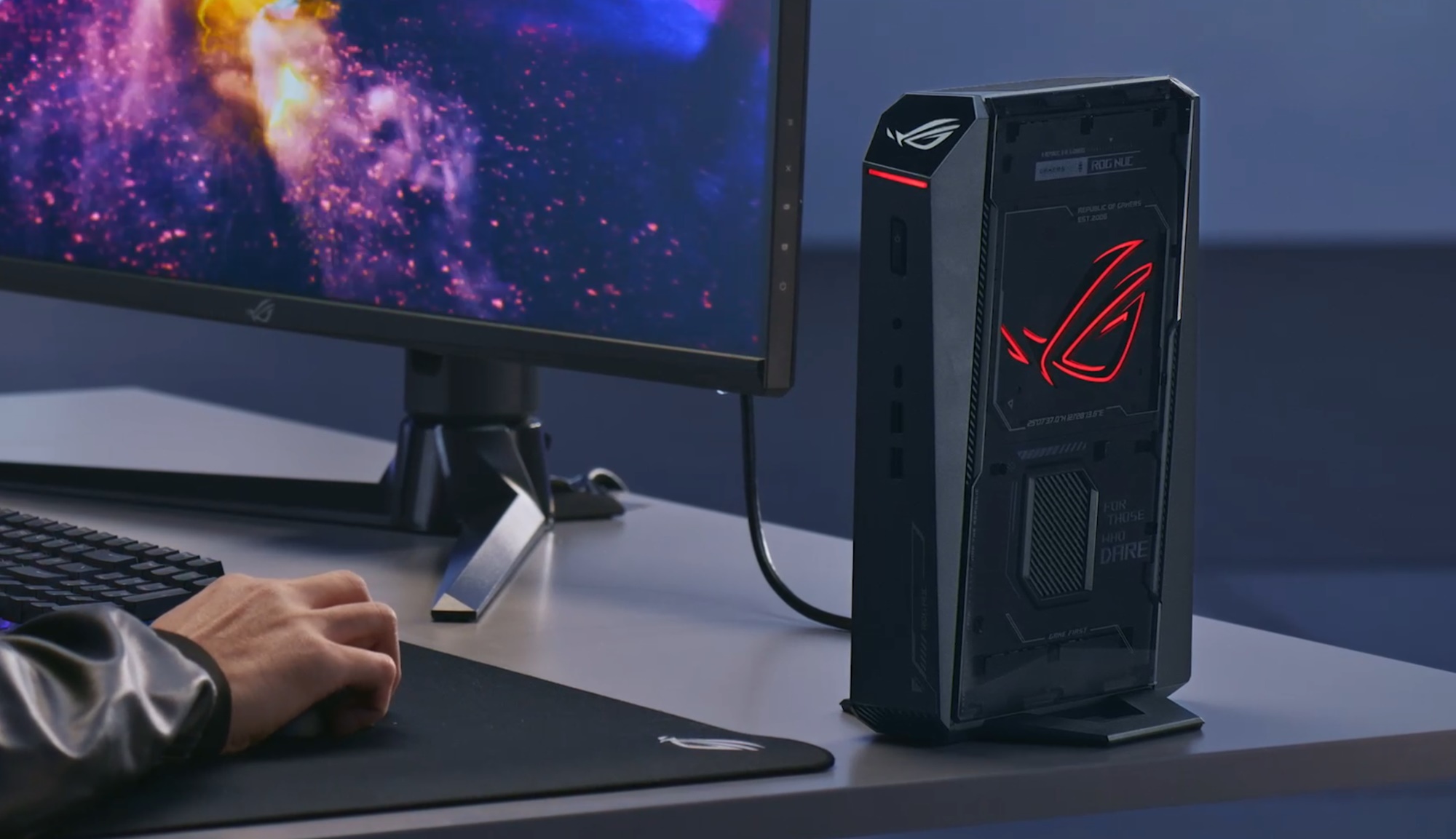 The 2025 ROG NUC on a desk beside a monitor.