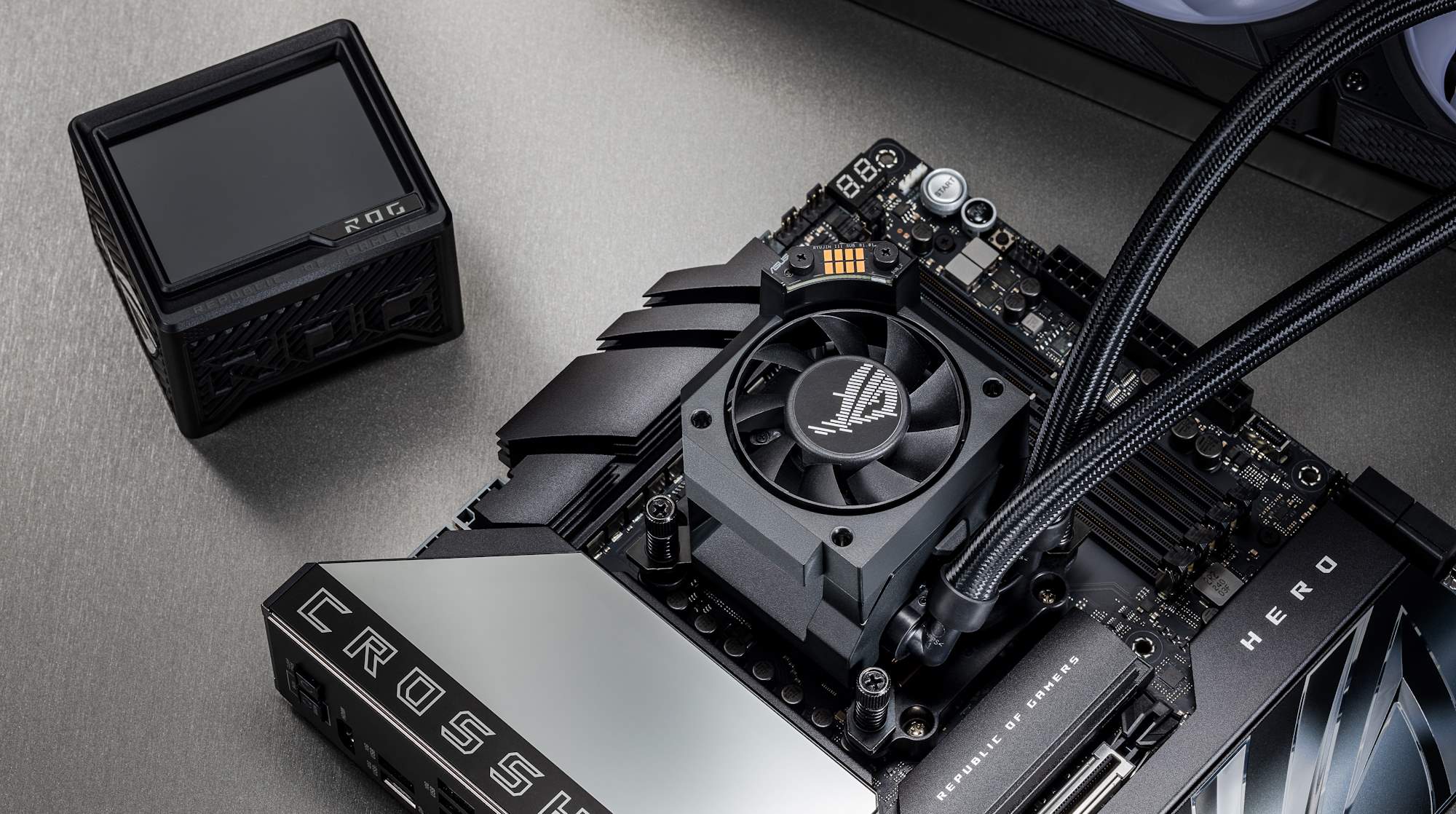 The ROG Crosshair X870E Hero motherboard laying flat on the table with other PC DIY parts nearby