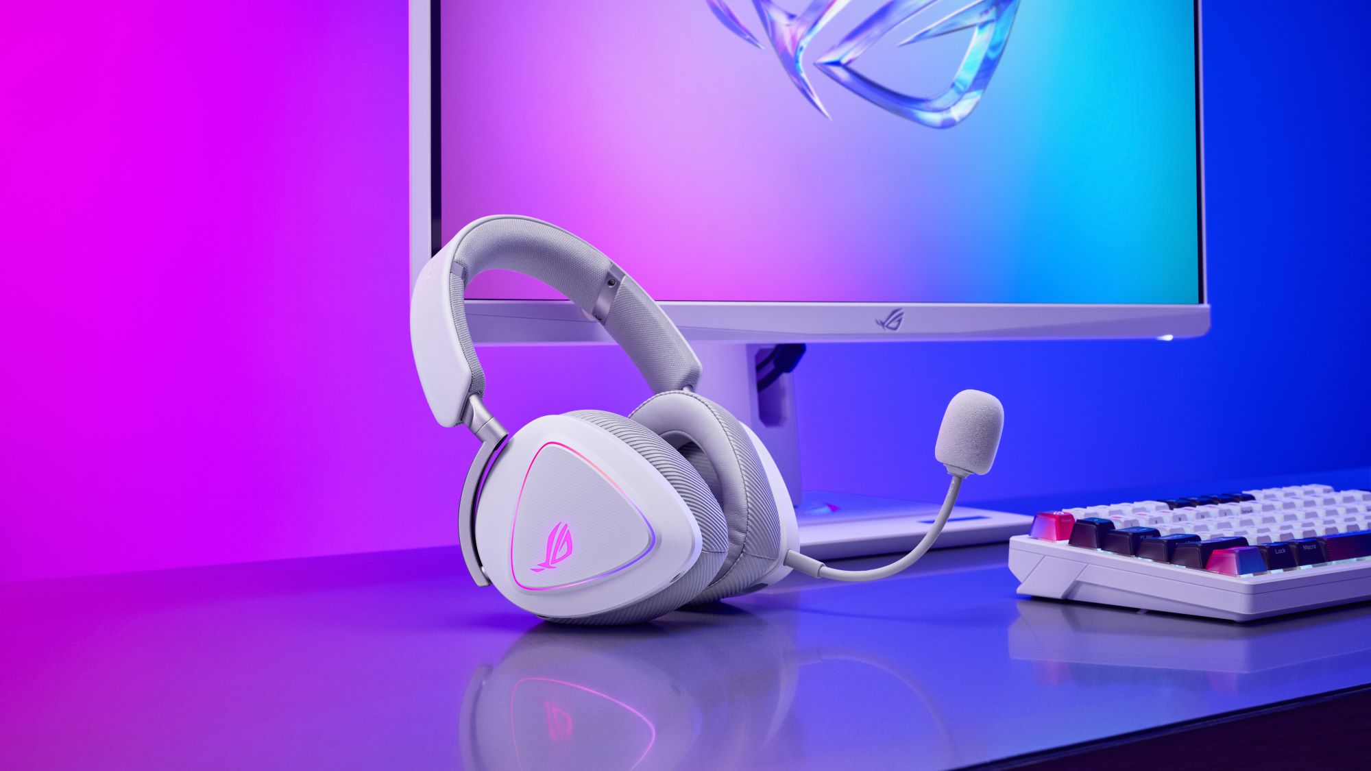 The Moonlight White ROG Delta II headset and ROG Azoth X keyboard on a desk, set against a purple-blue gradiant background.