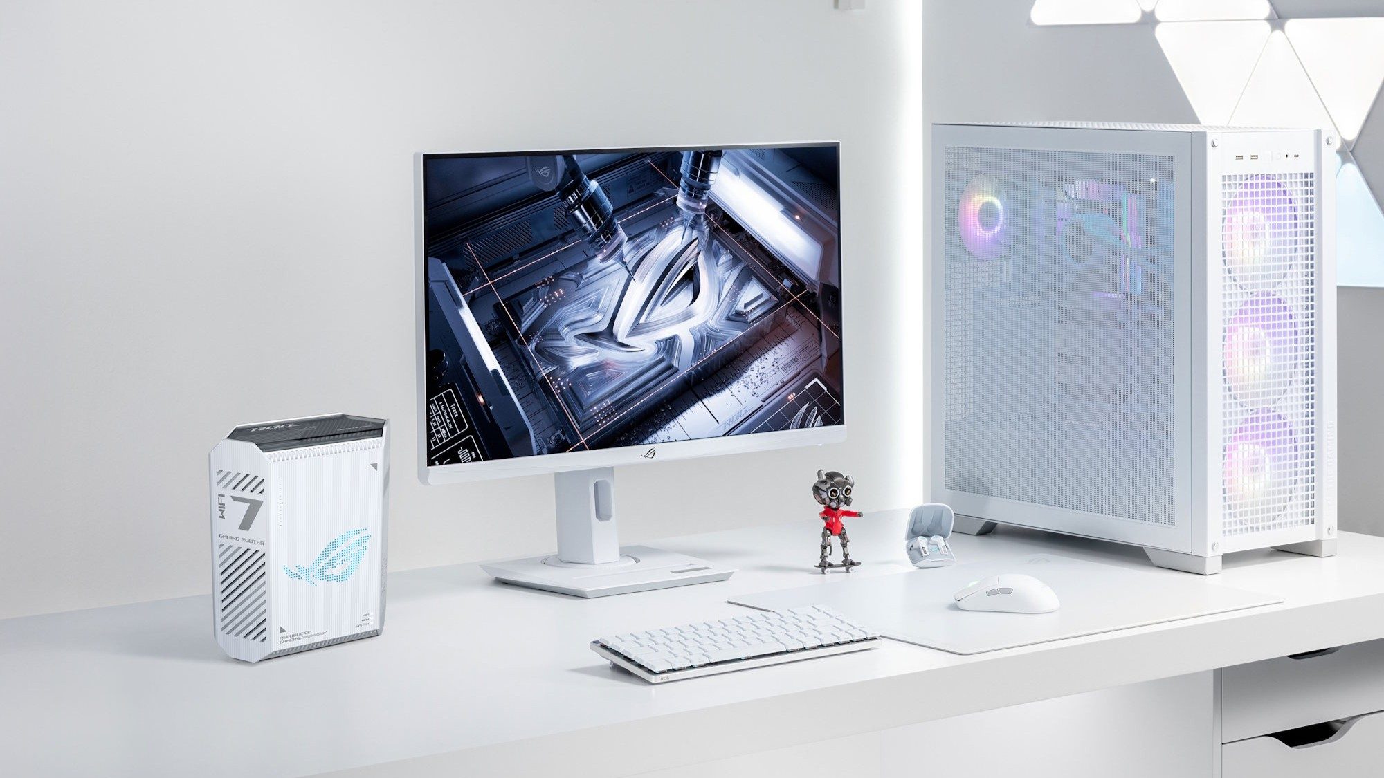 The ROG Strix GS-BE7200 alongside ROG peripherals on a white desk against a white backdrop