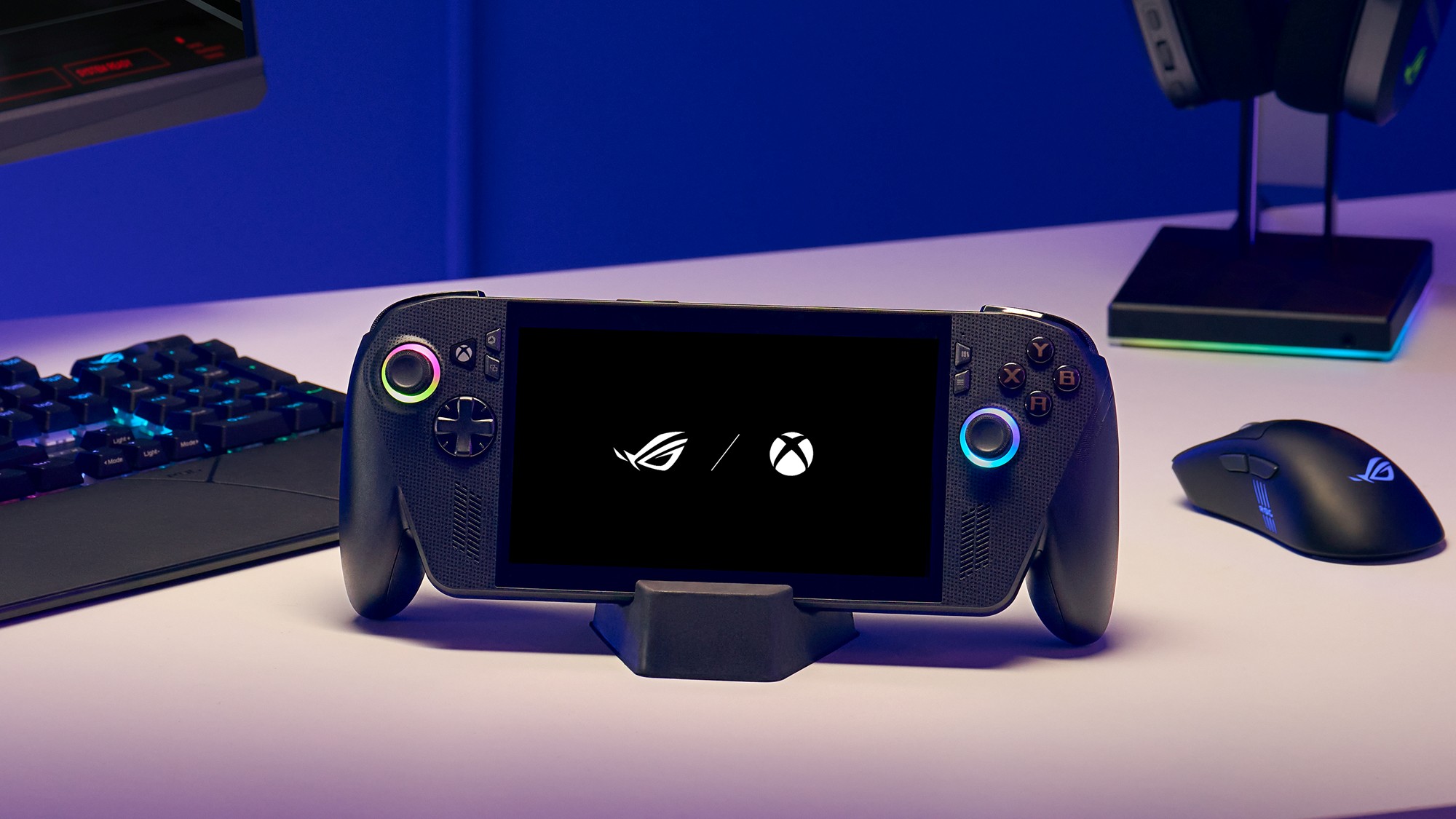 The ROG Xbox Ally X standing on a desk next to a mouse and keyboard