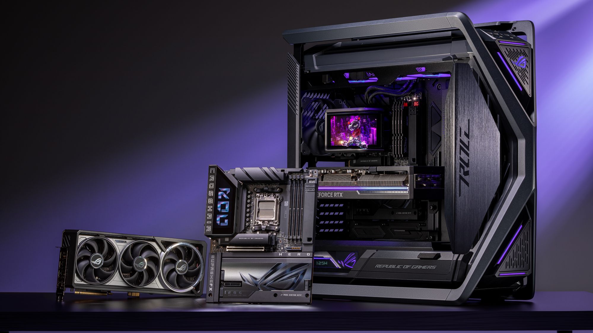 The ROG Crosshair X870E Hero BTF motherboard positioned next to an ROG PC case and ROG graphics card on a desk against a purple background.