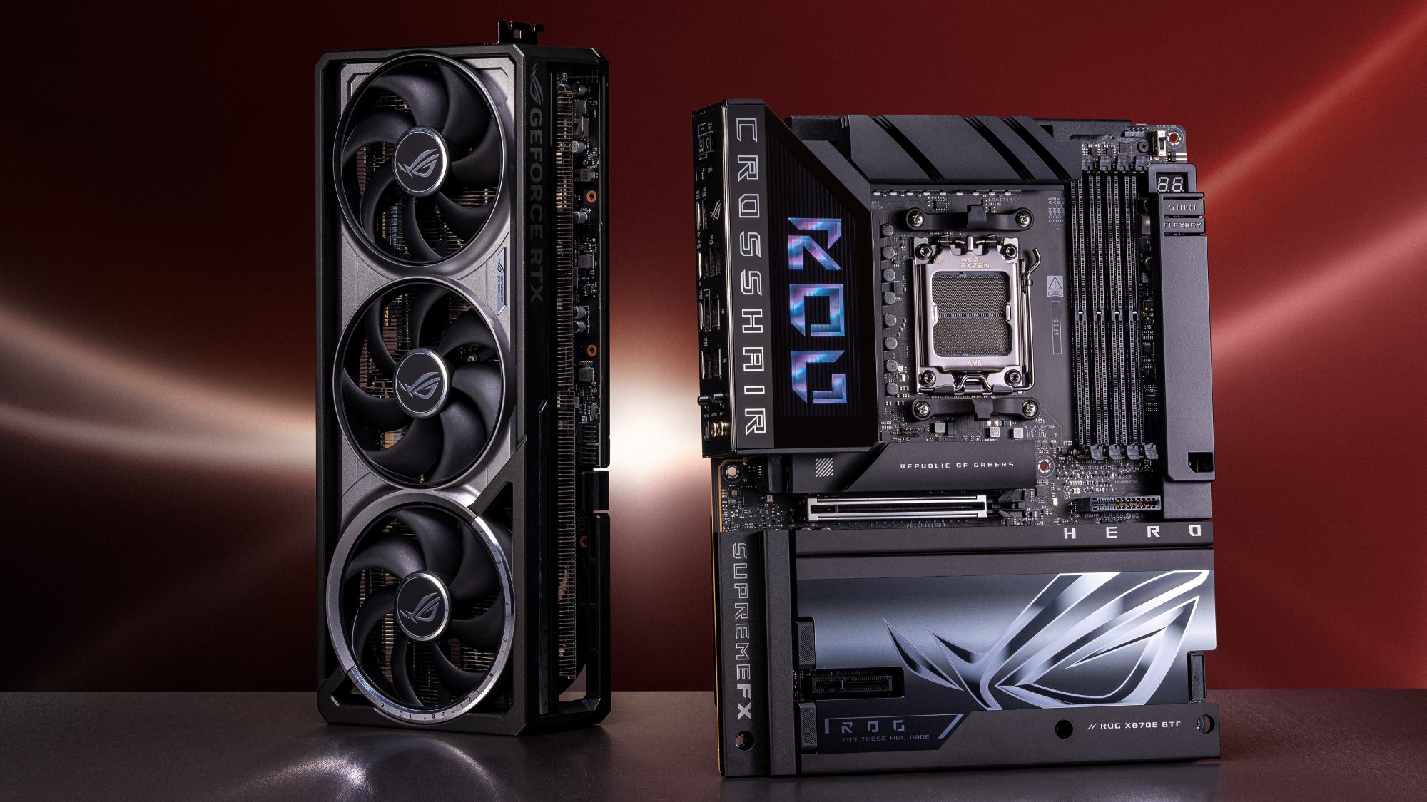 The ROG Crosshair X870E Hero BTF motherboard positioned next to an ROG graphics card on a desk.