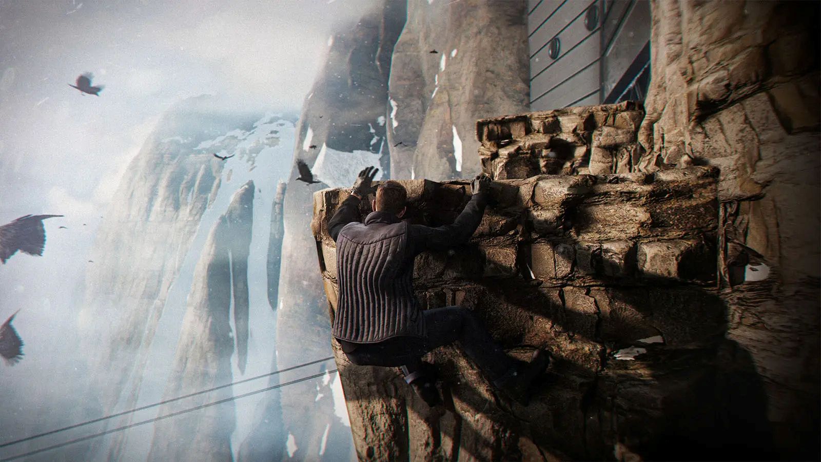 James Bond dangles from a cliff in 007 First Light.