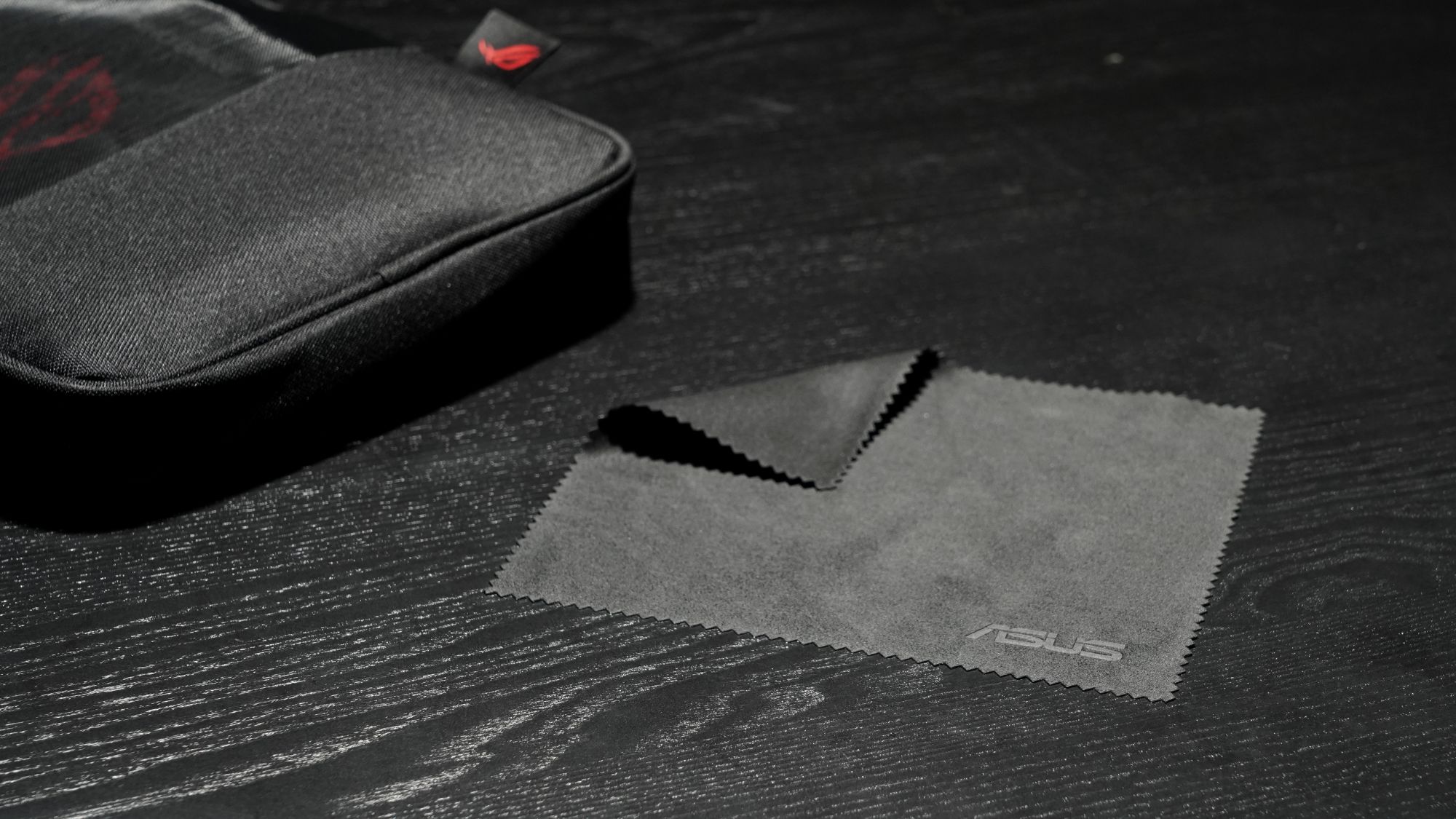 An ROG Microfiber cloth on a desk.